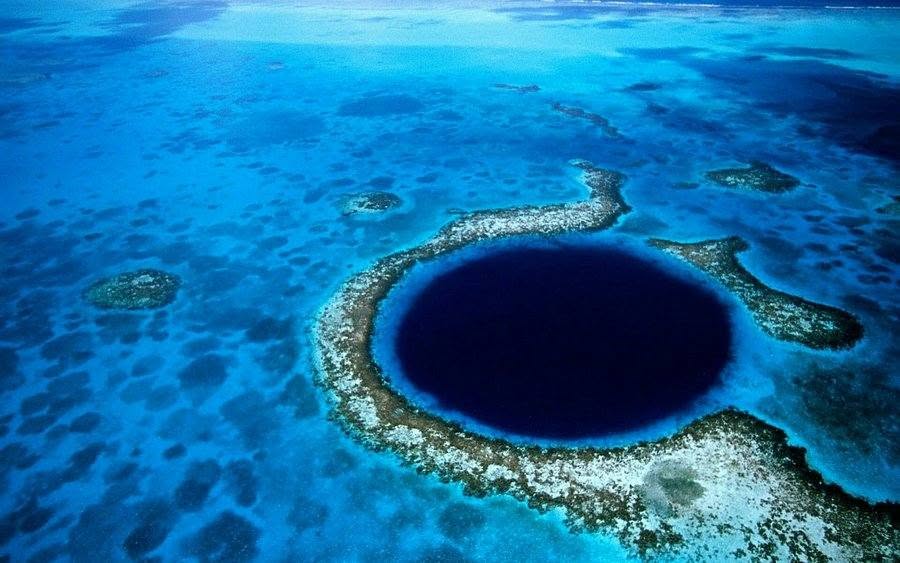 Aerial view of the Great Blue Hole within its surrounding reef